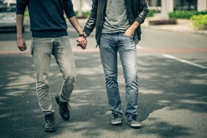 Cropped image of gay couple holding hands